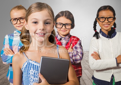 Girls with tablet in front of grey wall