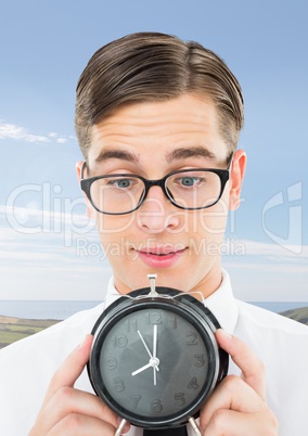 man holding clock in front of sky