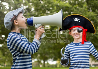 Boy holding megaphone and pirate in front of trees