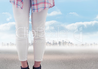 Woman's legs in front of city landscape