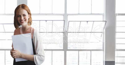 Happy business woman standing against building background