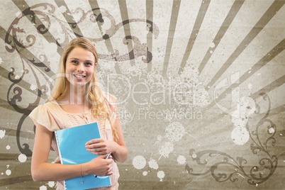 Happy young student woman holding a notebook against brown and white splattered background