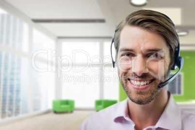 Happy customer care representative man against office background