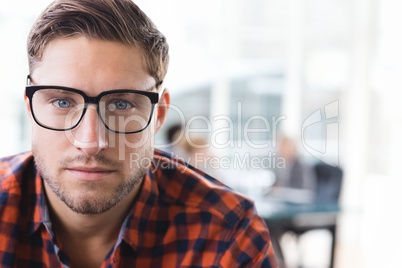 Business man standing against office background