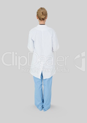 Full body portrait of doctor woman standing with grey background