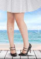 women's legs and skirt in front of sea and beach