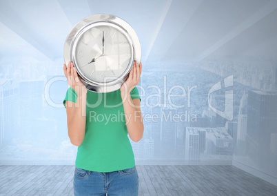 Woman holding clock in front of city room