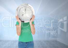 Woman holding clock in front of city room