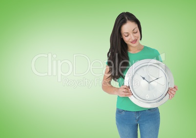 Woman holding clock in front of green background