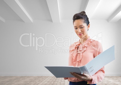Business woman holding a folder against white wall background
