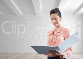 Business woman holding a folder against white wall background