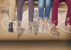 Group of people's legs sitting on wooden plank in front of world map