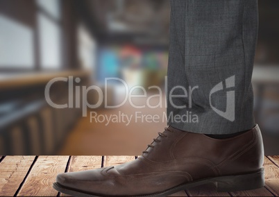 Businessman's foot and shoe on wood