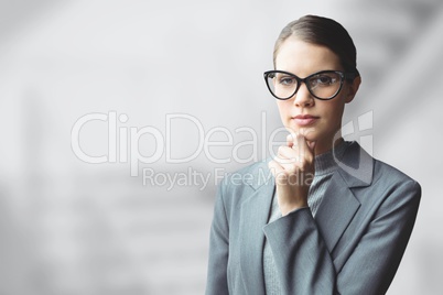 Business woman thinking against grey blurred background