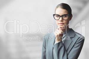 Business woman thinking against grey blurred background