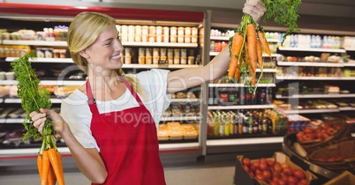 Happy small business woman holding carrots