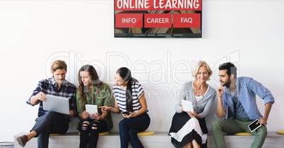 People sitting under a TV with e-learning information in the screen