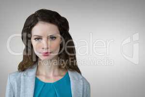 Business woman standing against grey background