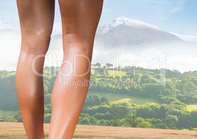Slim athletic legs in front of mountains landscape