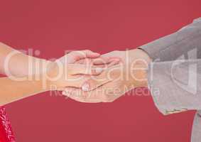 Couple's hands holding together with red background
