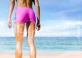 Slim athletic legs on bright beach