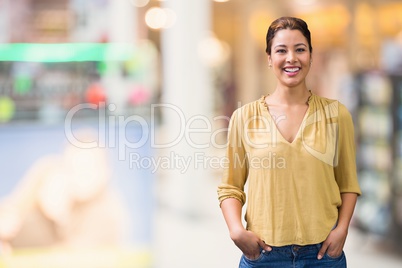 Happy business woman standing against background with lights