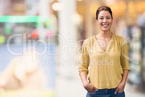 Happy business woman standing against background with lights