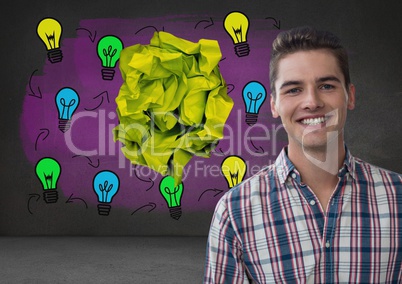 Man standing next to light bulbs with crumpled paper ball