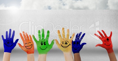 Colorful hands in front of wall