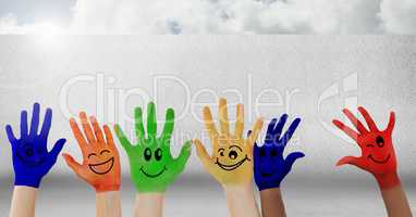 Colorful hands in front of wall
