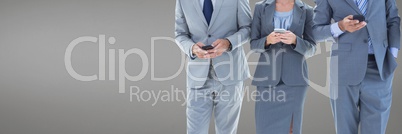Business people using phones against grey background