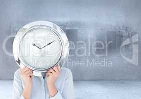 Woman holding clock in front of city imprinted on wall in room