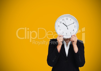 Woman holding clock in front of yellow background