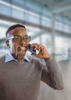 Happy business man talking on the phone against office background