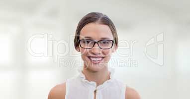 Happy business woman standing against white blurred background