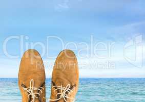 Shoes relaxing feet in front of sea