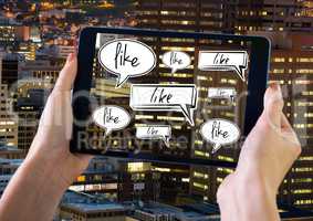 Holding tablet and Like chat bubbles in city