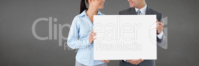 Business people holding a blank card against grey background