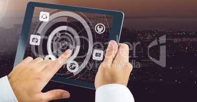 Holding tablet and City with icons interface radar
