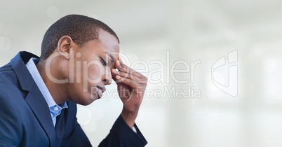 Worried business man standing against white blurred background