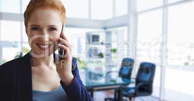 Business woman talking on the phone against office background