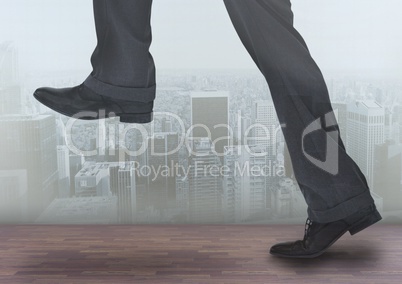 Businessman's legs over city