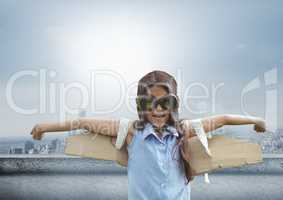 Pilot girl with wings over city background