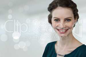 Happy business woman standing against white blurred background