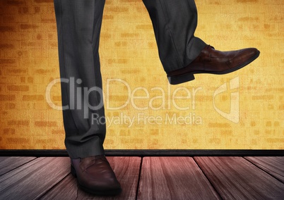 Mans legs and feet on wooden floor