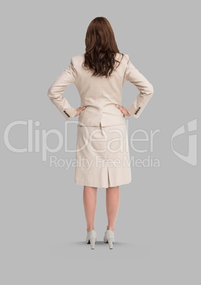 Full body portrait of woman standing with grey background
