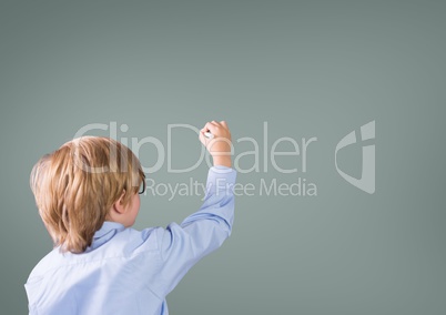 Boy writing in front of grey blank background