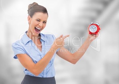 Woman holding clock in front of bright blurred background