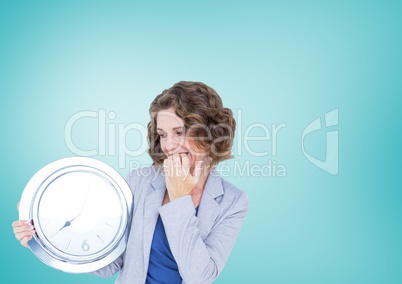 Woman holding clock in front of blue background