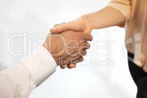Business people shaking hands against white background